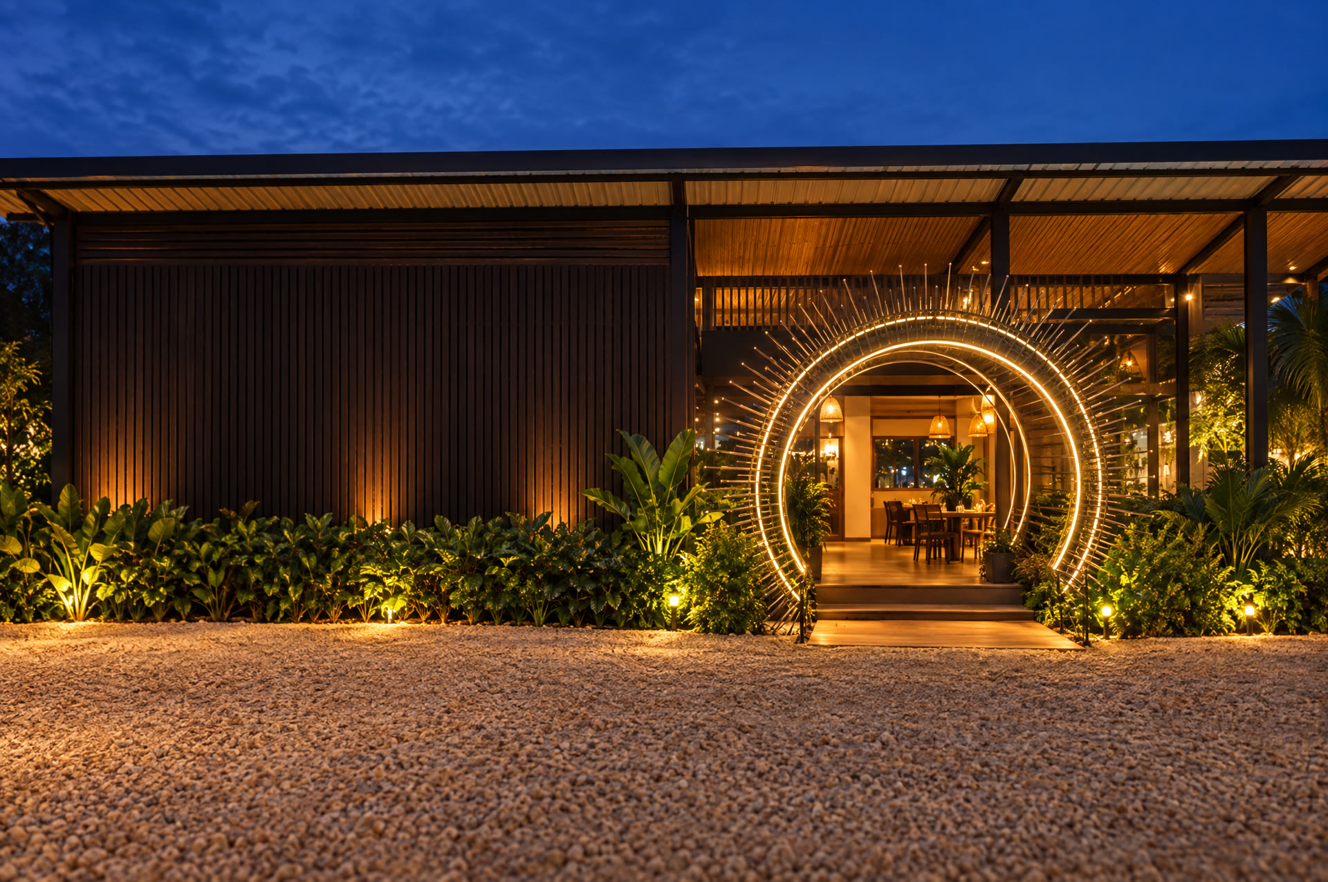 Fachada da pizzaria à noite com o arco de entrada iluminado